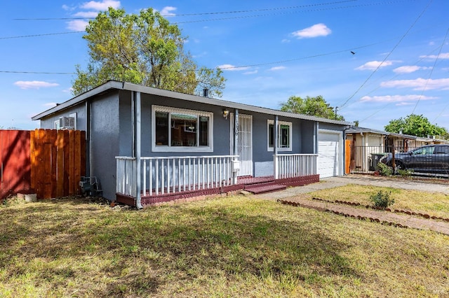 ranch-style house with driveway, a front lawn, an attached garage, a porch, and fence