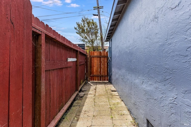 view of property exterior with stucco siding and fence