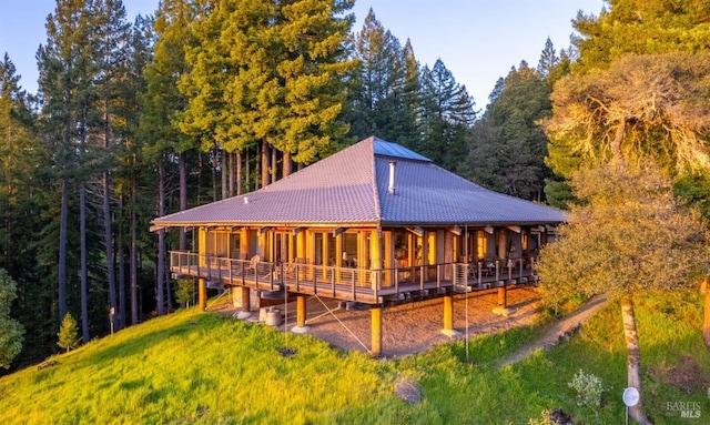 rear view of house with a wooded view