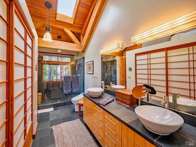 full bath with a sink, a skylight, toilet, and wood ceiling