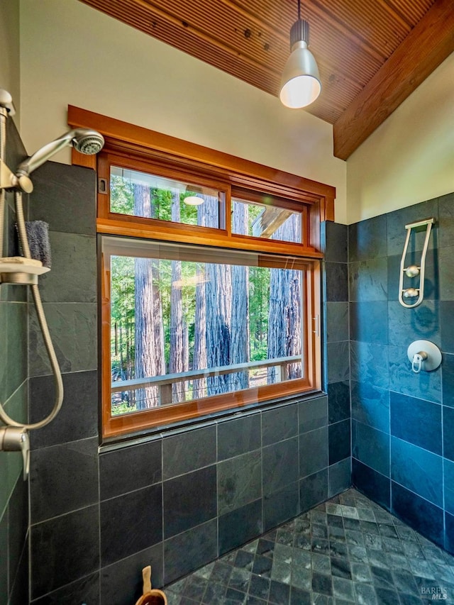 full bathroom with beam ceiling, tiled shower, and wooden ceiling