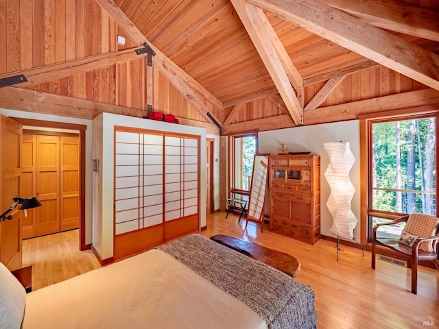 bedroom featuring wood finished floors, lofted ceiling with beams, and wooden ceiling
