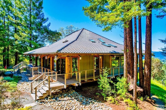 exterior space featuring a tiled roof