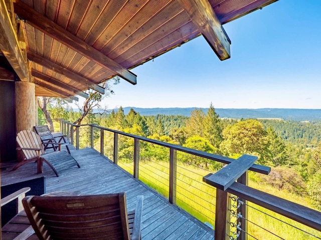 wooden terrace with a wooded view