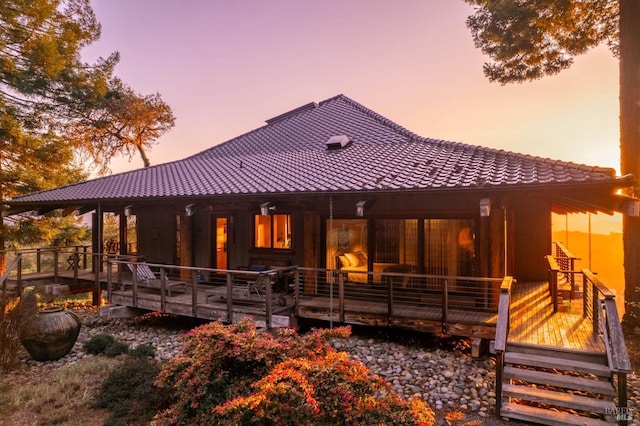 back of house with a tile roof