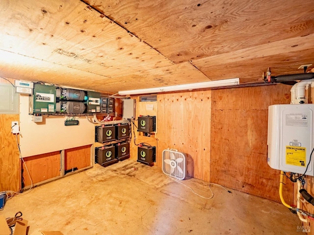 below grade area with wooden walls, tankless water heater, and wooden ceiling