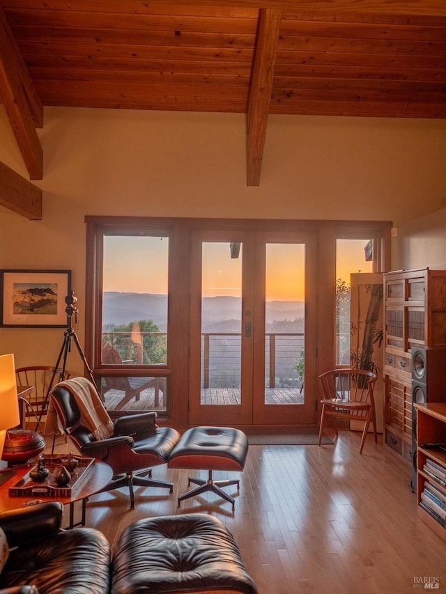 living area featuring french doors, wood ceiling, hardwood / wood-style floors, and beam ceiling