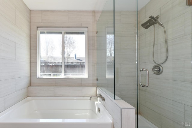 bathroom with a bath and a shower stall