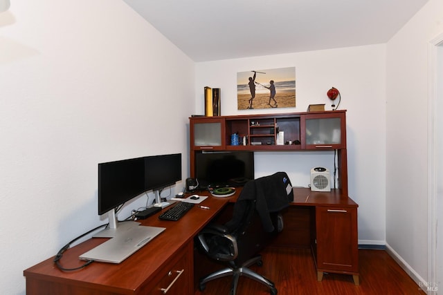 office area with dark wood-type flooring and baseboards