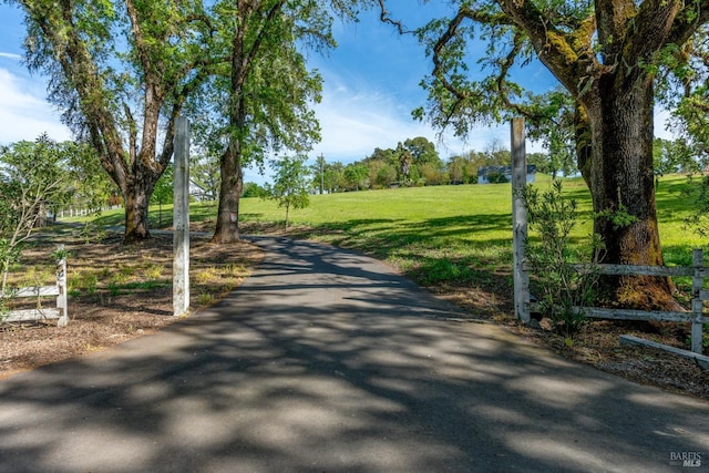 surrounding community featuring fence and a lawn
