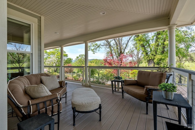 sunroom featuring an outdoor hangout area