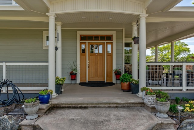 view of exterior entry with a porch