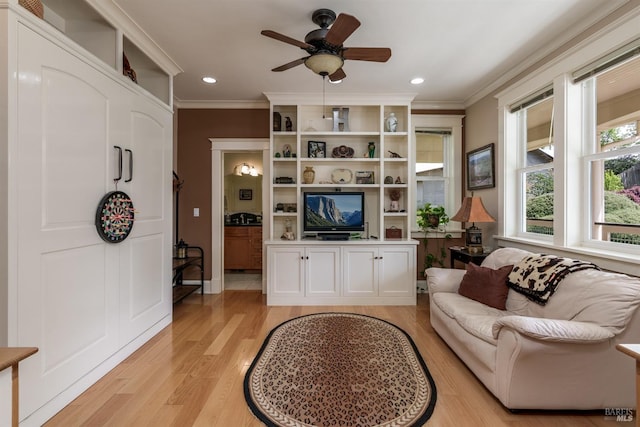 living area featuring crown molding, light wood finished floors, and recessed lighting