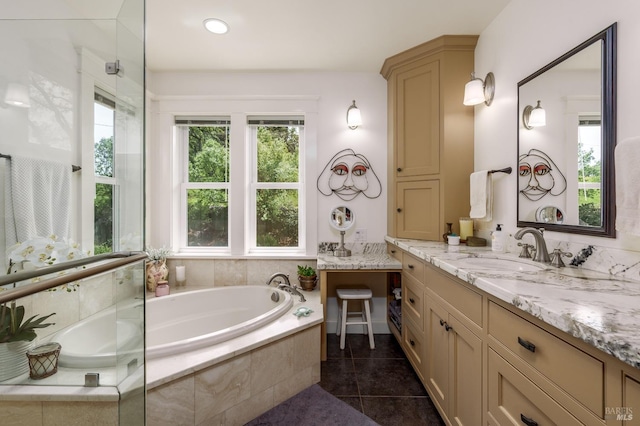full bath with a garden tub, vanity, and tile patterned flooring