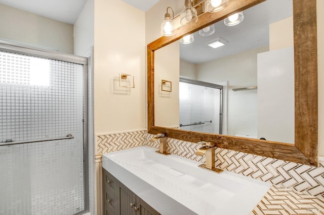 bathroom featuring a shower stall and vanity