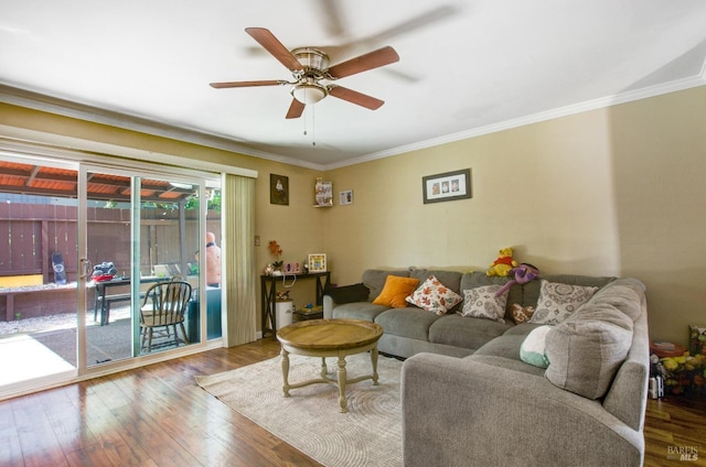 living area featuring ornamental molding, a ceiling fan, and wood finished floors