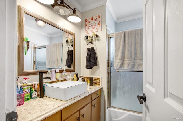 bathroom featuring bath / shower combo with glass door, vanity, and ornamental molding
