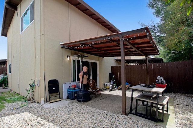 back of property featuring a patio, stucco siding, and fence