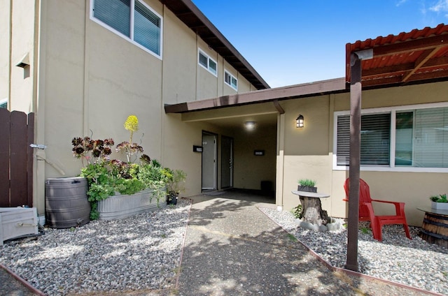 view of exterior entry featuring stucco siding