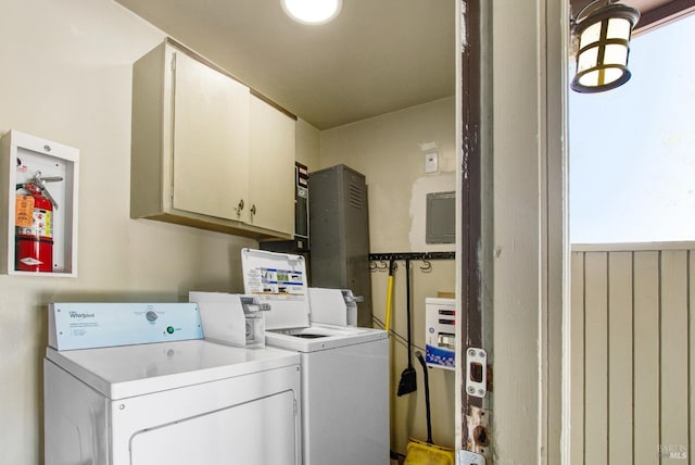 washroom featuring independent washer and dryer and cabinet space