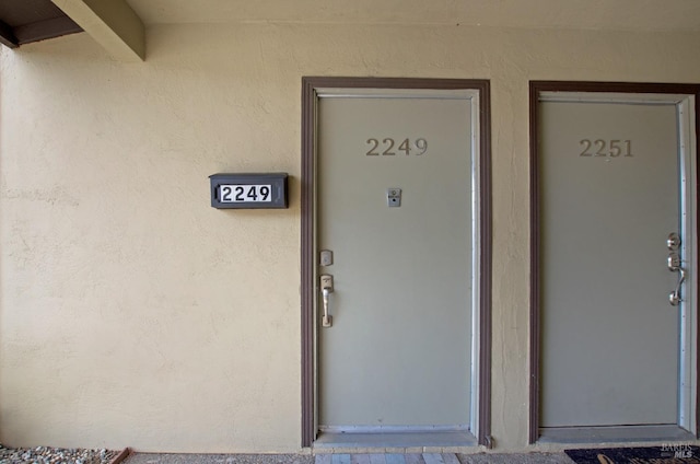 doorway to property with stucco siding