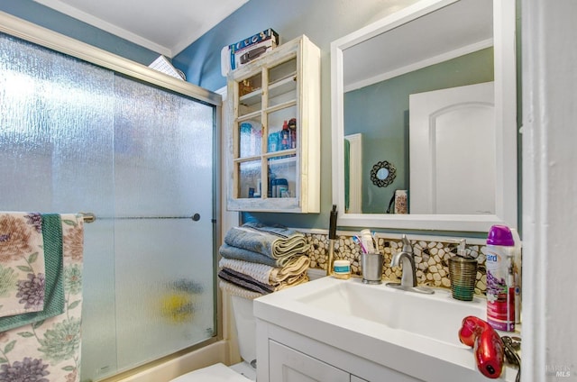 bathroom featuring toilet, crown molding, enclosed tub / shower combo, and vanity