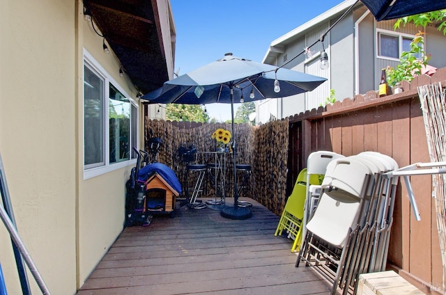 wooden terrace featuring fence