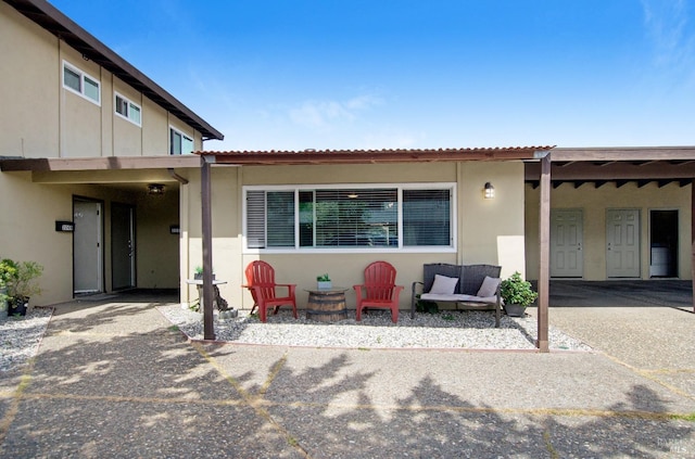 back of property featuring a patio area and stucco siding