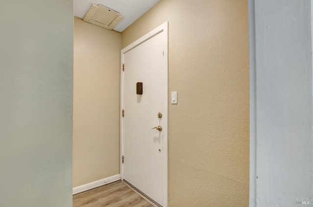 interior space with light wood finished floors and baseboards