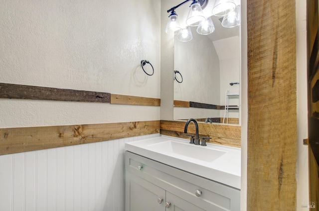 bathroom with vanity and a textured wall