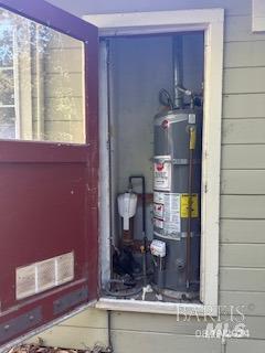 utilities featuring water heater and visible vents