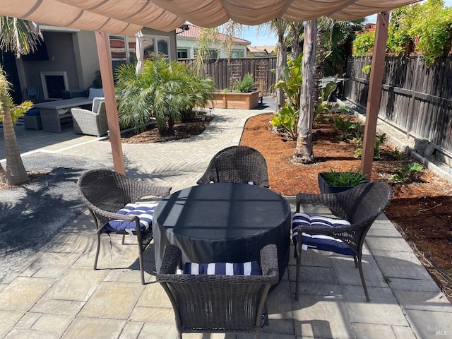 view of patio / terrace with outdoor lounge area, fence, outdoor dining area, and a pergola