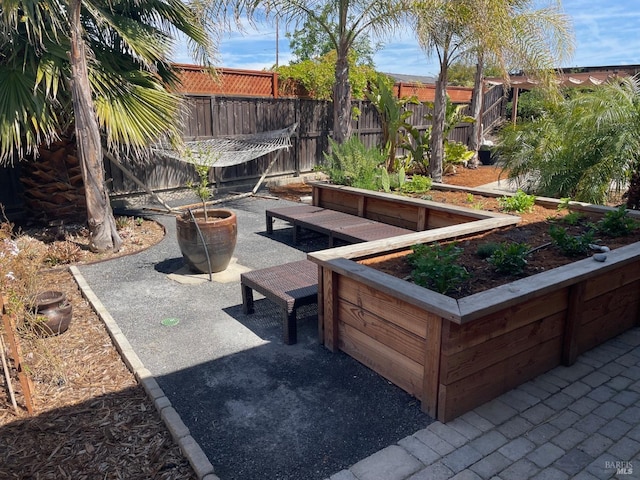 view of patio / terrace with a garden and fence