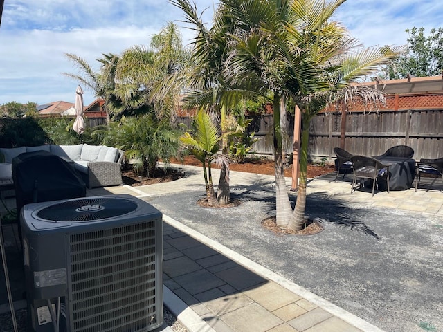 view of yard with a patio area, an outdoor living space, cooling unit, and fence