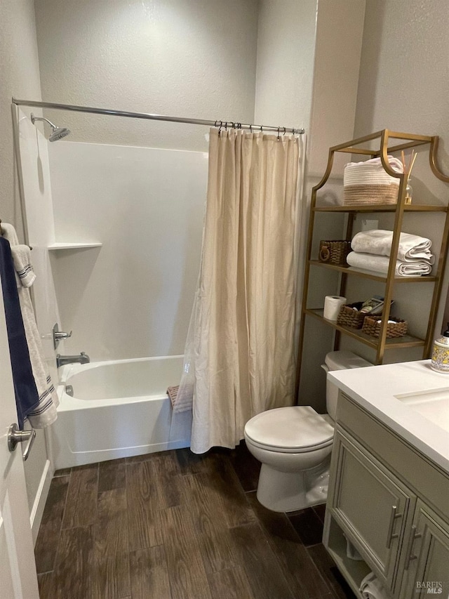 full bath featuring a textured wall, shower / bath combination with curtain, toilet, and wood finished floors