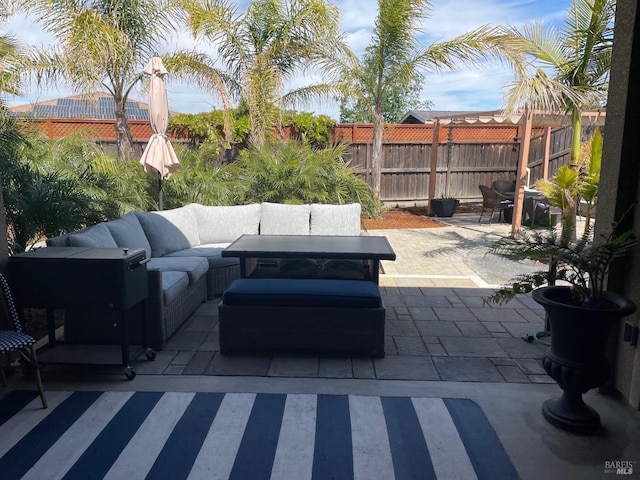 view of patio featuring an outdoor hangout area and fence