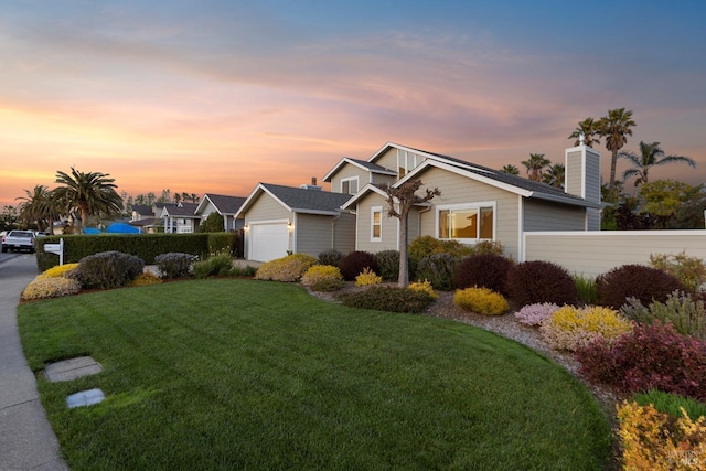 ranch-style house with an attached garage, a chimney, a front yard, and fence
