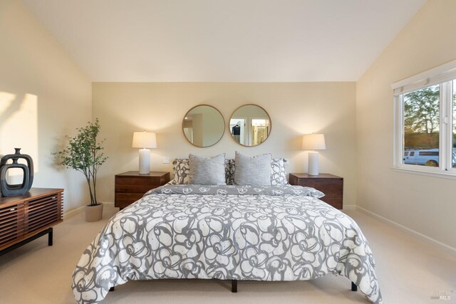 bedroom featuring carpet flooring, baseboards, and vaulted ceiling
