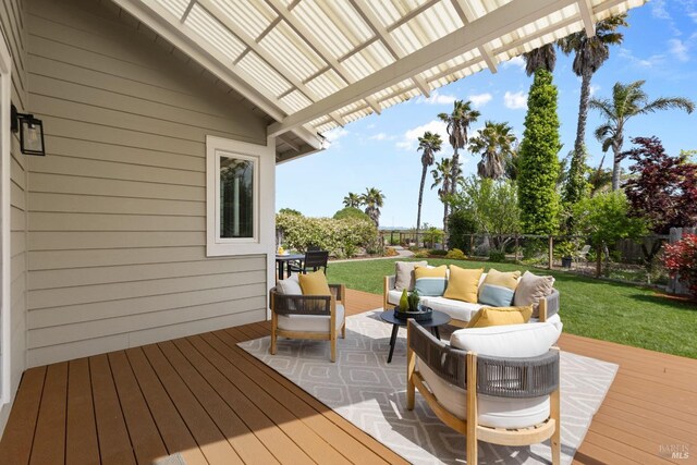wooden deck featuring fence, a lawn, and an outdoor hangout area