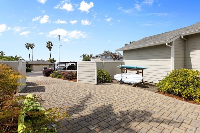 view of patio featuring fence and a gate