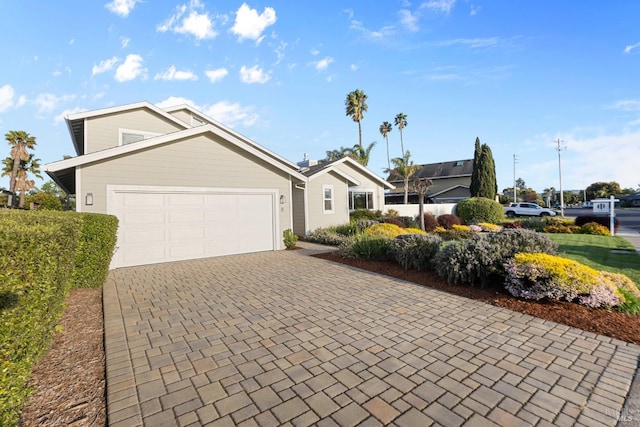 view of front facade with decorative driveway and an attached garage