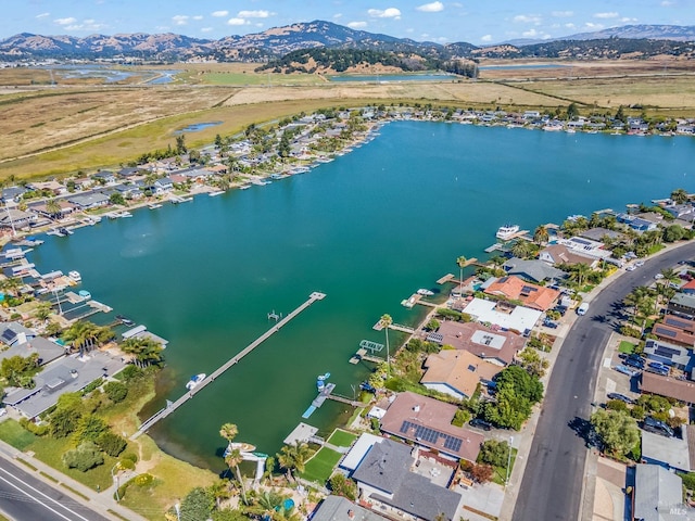 birds eye view of property featuring a water and mountain view and a residential view