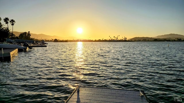 view of dock featuring a water and mountain view