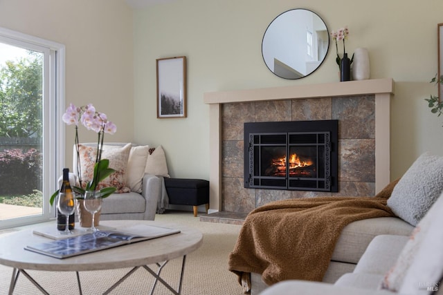 living area featuring a tile fireplace
