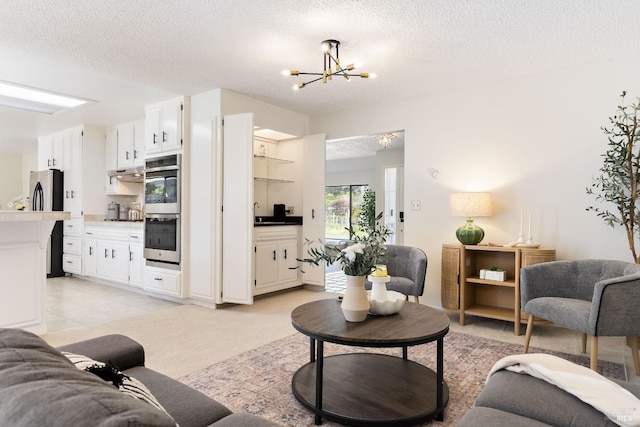 living area featuring a notable chandelier and a textured ceiling