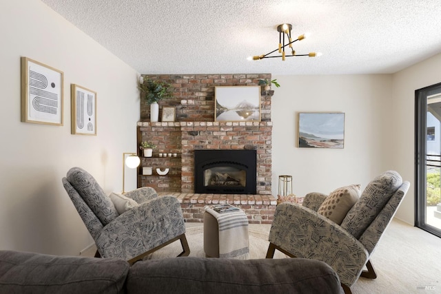 carpeted living room with a fireplace, a notable chandelier, and a textured ceiling