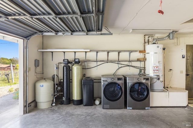 washroom featuring laundry area, a garage, water heater, and washer and clothes dryer