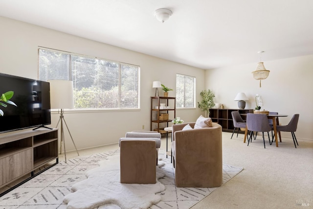 living area with light carpet and baseboards
