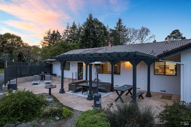 back of house featuring a pergola, a tiled roof, board and batten siding, fence, and a patio