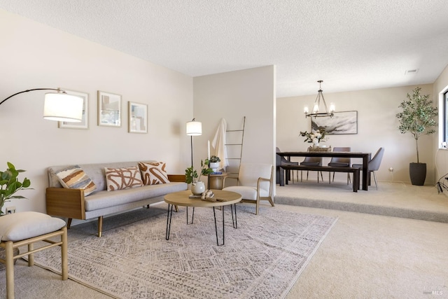 living room featuring a textured ceiling, carpet flooring, and an inviting chandelier